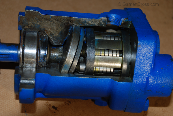 Oil Hydraulics Piston Pump with Cut-away to expose the Rotating Group, Shoe Piston Shoe Retainer Plate, Swash Plate, Shaft, Seal, Bearing and Circlip.